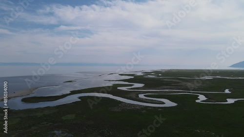 the picturesque mouth of the Goloustnaya river at different times of the year on the shores of Lake Baikal photo