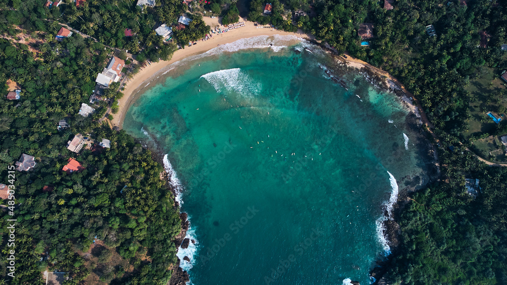 Aerial view of Hiriketiya Beach in Dikwella. Blue beach in Sri Lanka. Indian Ocean