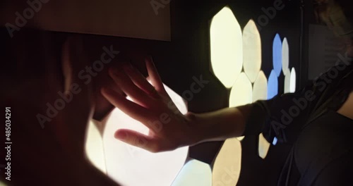 female hands playing with an interactive touch light panel. art therapy or relaxation with the help of technology