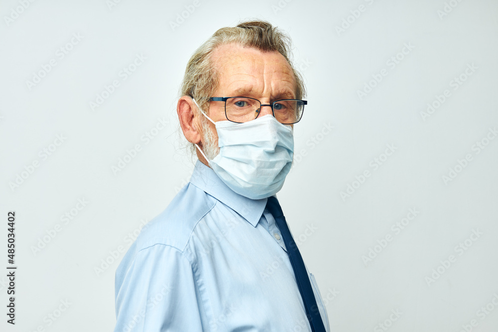Portrait of happy senior man medical safety mask health light background Portrait of happy senior man medical safety mask health light background