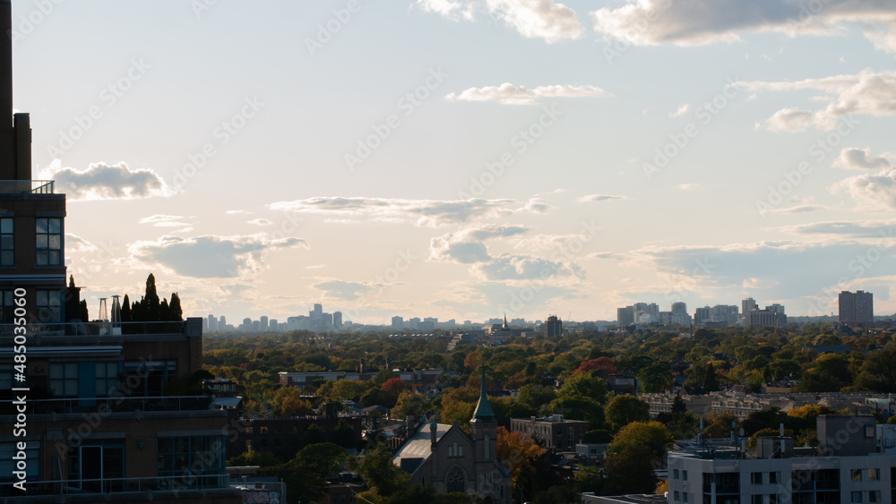 Toronto city under autumn blue sky with small clouds