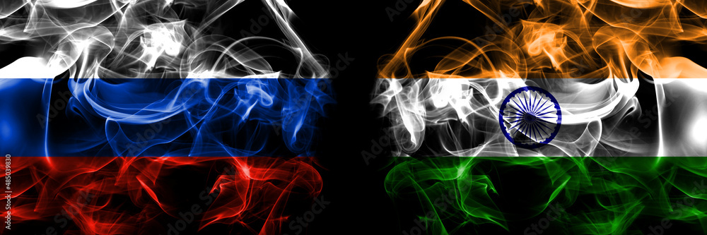 Obraz premium Russia, Russian vs India flags. Smoke flag placed side by side isolated on black background