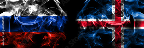 Russia  Russian vs Iceland  Icelandic flags. Smoke flag placed side by side isolated on black background