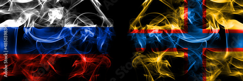 Russia, Russian vs Ingrian people flags. Smoke flag placed side by side isolated on black background photo