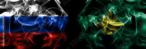 Russia, Russian vs Japan, Japanese, Iwamizawa, Hokkaido, Sorachi, Subprefecture flags. Smoke flag placed side by side isolated on black background photo