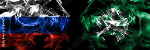 Russia, Russian vs Japan, Japanese, Iwanai, Hokkaido, Shiribeshi, Subprefecture flags. Smoke flag placed side by side isolated on black background photo