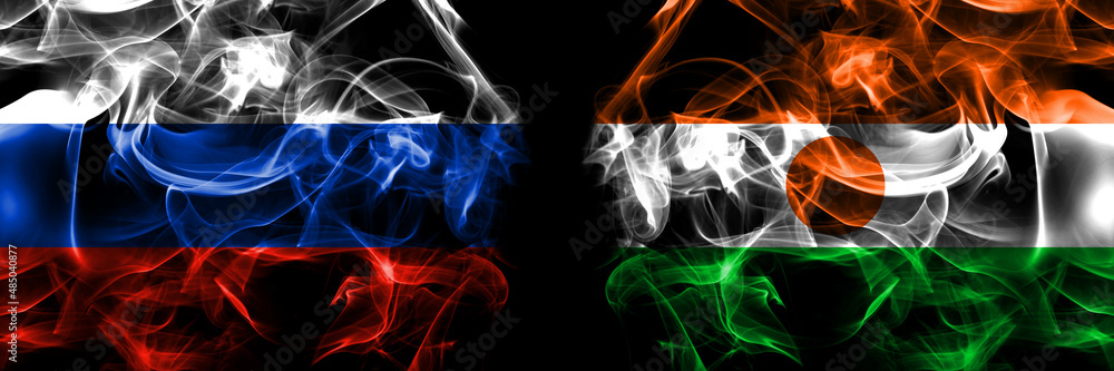 Russia, Russian vs Niger, Nigerien flags. Smoke flag placed side by side isolated on black background