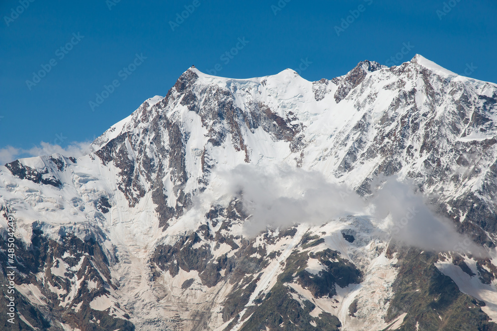 Panoramic view of the east peak of Monte Rosa with snow during summer season, Italy