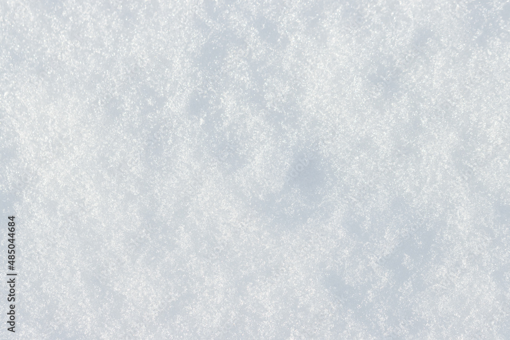 Natural snow texture. Smooth surface of clean fresh snow. Snowy ground. Winter background with snow patterns. Perfect for Christmas and New Year design. Closeup top view.