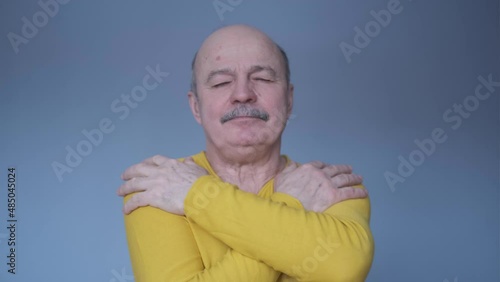 Senior hispanic man coughing because of pulmonary disease