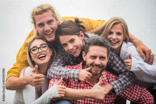 Happy friends from diverse cultures and races taking selfie with thumb up. Youth and friendship concept. Group of friends laughing out loud outdoor, good and positive mood. © Volodymyr