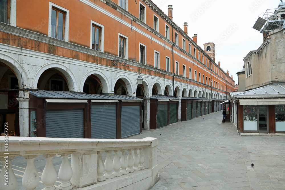 wide desert street in Venice with closed windows and closed shutters without people due to the economic crisis during the lockdown in Italy wide desert street in Venice with closed windows and closed shutters without people due to the economic crisis during the lockdown in Italy