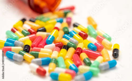 colorful capsule pills and bottle