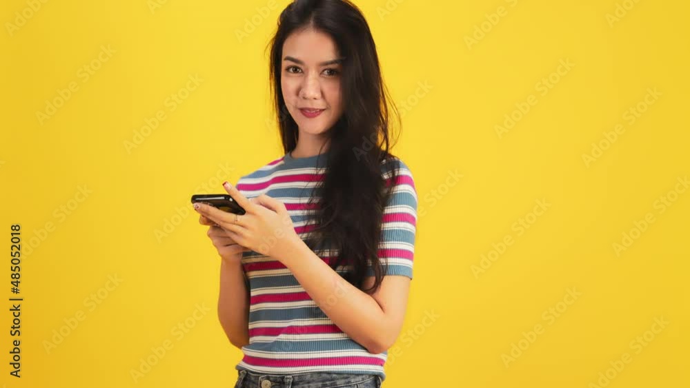 Happy attractive asian young woman dancing isolated on yellow background.Cheerful pretty girl happy with tablet notebook online music smiling and moving body follow music with positive. Happy attractive asian young woman dancing isolated on yellow background.Cheerful pretty girl happy with tablet notebook online music smiling and moving body follow music with positive.