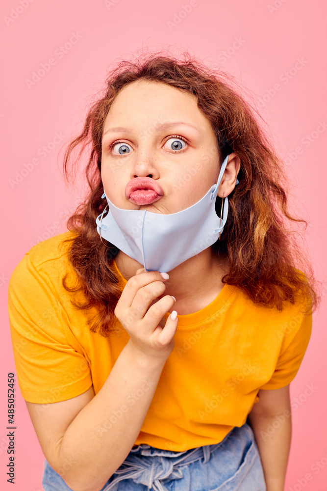 beautiful woman in a yellow t-shirt medical mask protection cropped view unaltered beautiful woman in a yellow t-shirt medical mask protection cropped view unaltered