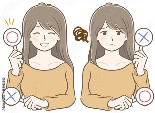 〇✕を持つロングヘアーの若い女性