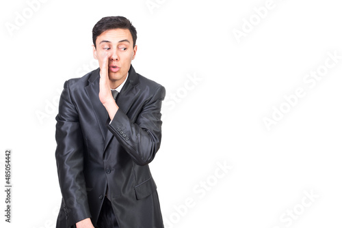 Confident handsome male showing gesture of whispering secret