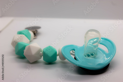 black baby pacifier on a white background