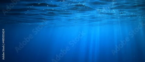 Obraz  z motywem ocean underwater rays of light background, under blue water sunlight