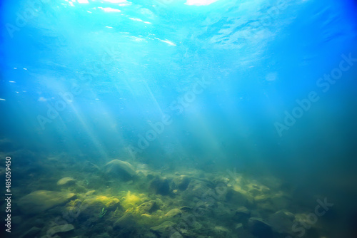 sun rays under water blue ocean background, abstract sun light in water wallpaper © kichigin19