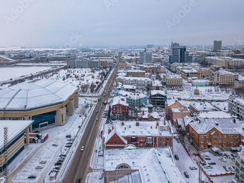 View of the center of Kazan from above. Low-rise apartment buildings, high-rise buildings and a sports center. Winter view.