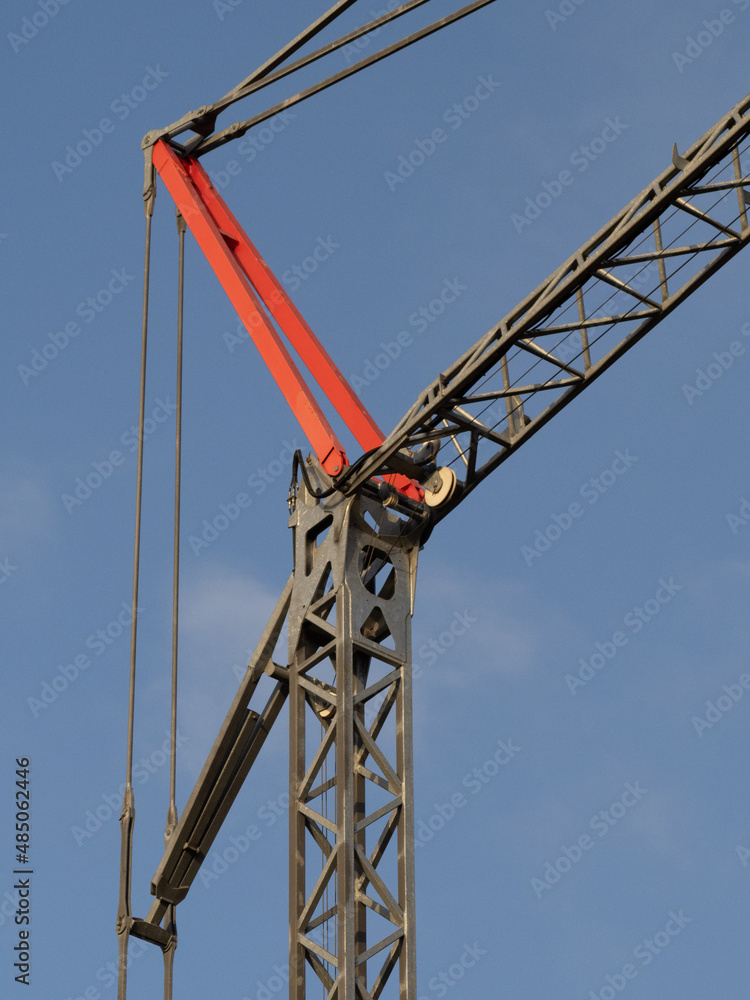 details of a large construction crane in the sun