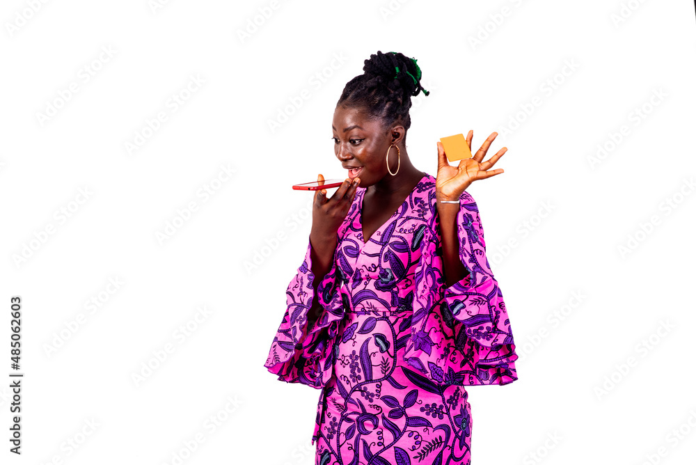 beautiful young businesswoman holding credit card and sending voice message on mobile phone. beautiful young businesswoman holding credit card and sending voice message on mobile phone.