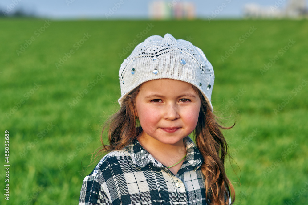 Happy little girl on a green meadow in the countryside. . Happy little girl on a green meadow in the countryside. .