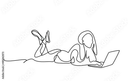 happy beautiful woman using laptop lying on floor