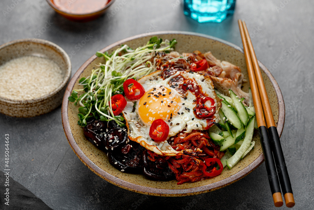 Traditional Korean dish Bibimbap. Bowl with rice, shiitake mushrooms