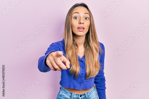 Beautiful hispanic woman wearing casual blue shirt pointing displeased and frustrated to the camera  angry and furious with you