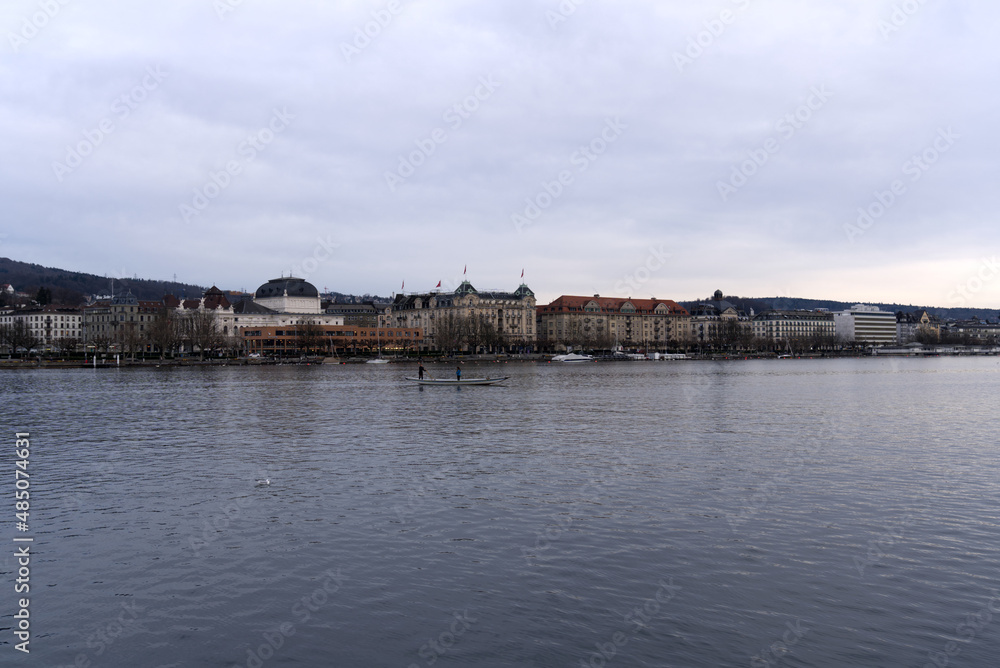 City of Zürich with lake Zürich in the foreground on a cloudy winter day. Photo taken February 3rd, 2022, Zurich, Switzerland.