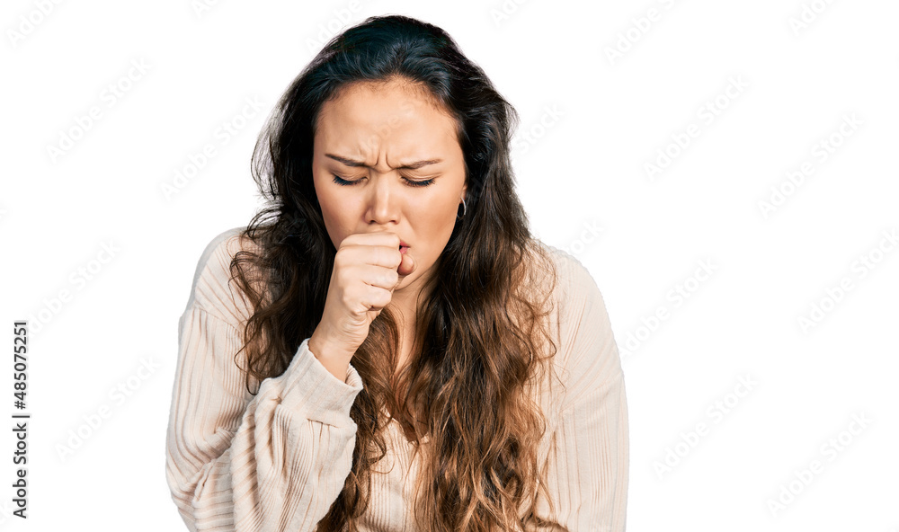 Young hispanic girl wearing casual clothes feeling unwell and coughing as symptom for cold or bronchitis. health care concept. Young hispanic girl wearing casual clothes feeling unwell and coughing as symptom for cold or bronchitis. health care concept.