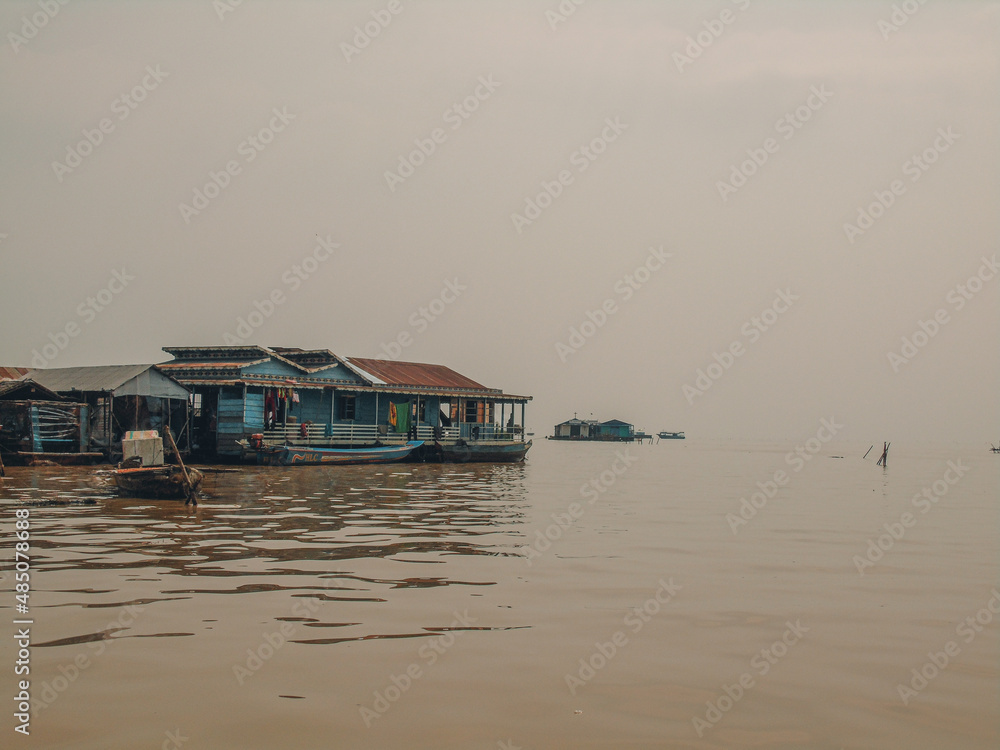 Floating village and boat on Tonlé Sap lake in Cambodia Floating village and boat on Tonlé Sap lake in Cambodia