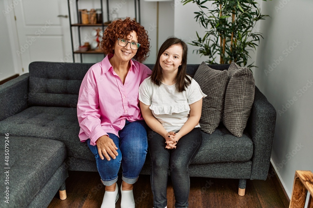 Obraz premium Mature mother and down syndrome daughter at home