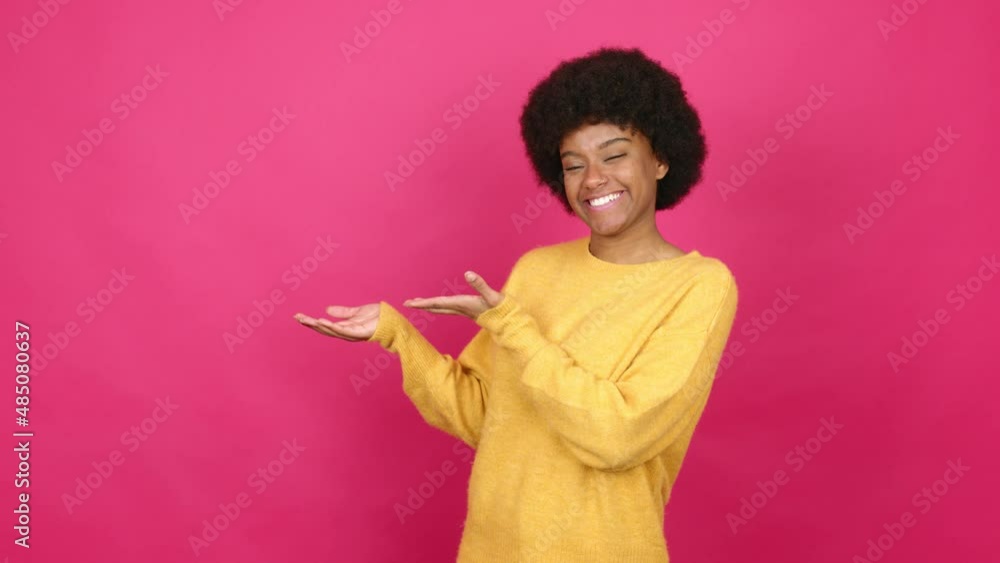 Young African American woman presenting something over isolated background Young African American woman presenting something over isolated background