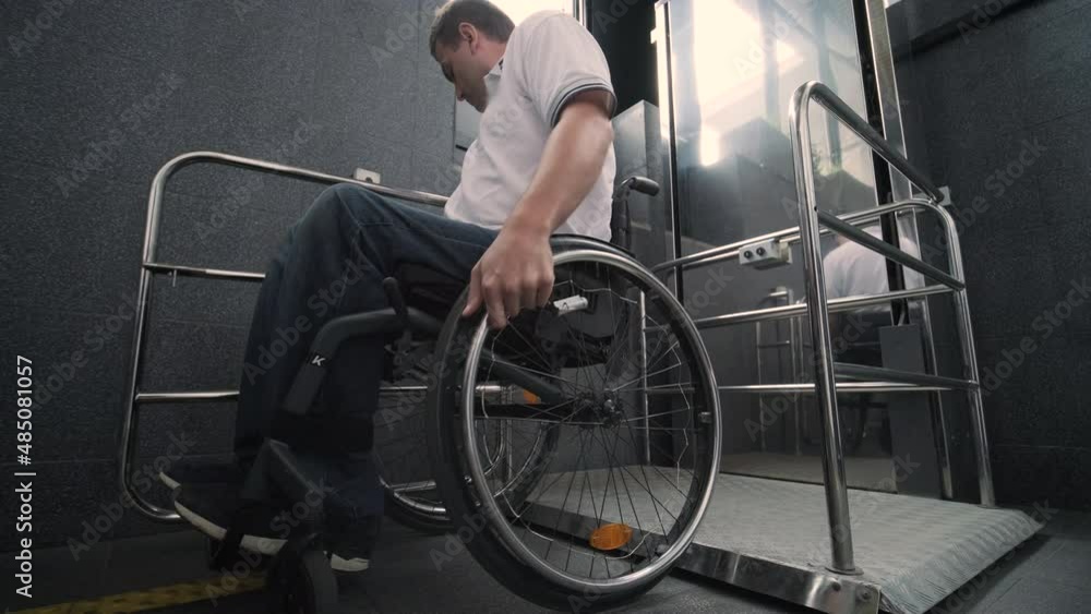 Special elevator for the person with a physical disabilities. A man in a wheelchair uses a special elevator Special elevator for the person with a physical disabilities. A man in a wheelchair uses a special elevator
