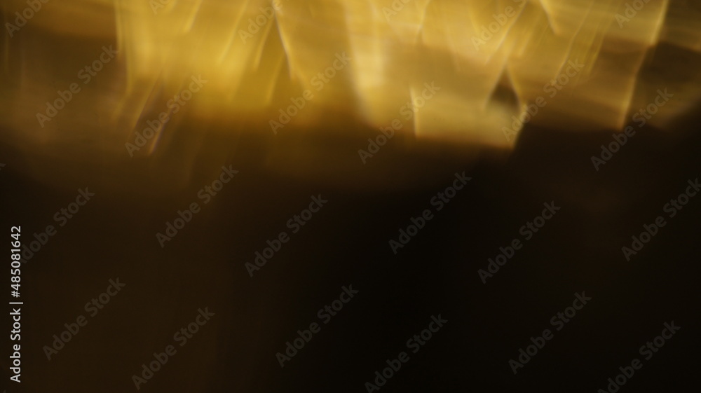 Golden bokeh crystal abstract light rays background, shiny flare texture photo overlay optical lens prism reflection. Use screen overlay mode. Golden bokeh crystal abstract light rays background, shiny flare texture photo overlay optical lens prism reflection. Use screen overlay mode.