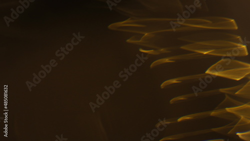 Golden bokeh crystal abstract light rays background, shiny flare texture photo overlay optical lens prism reflection. Use screen overlay mode.