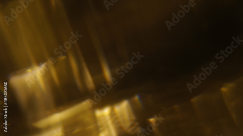 Golden bokeh crystal abstract light rays background, shiny flare texture photo overlay optical lens prism reflection. Use screen overlay mode.