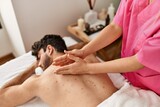 Man relaxed reciving back massage at beauty center.