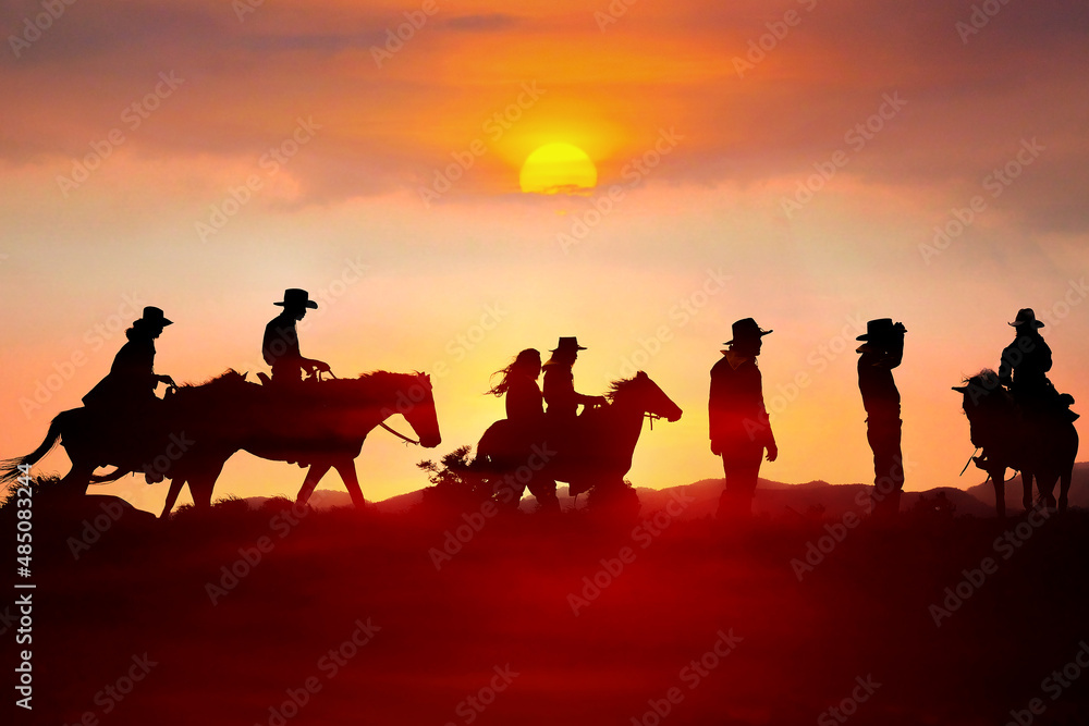 The silhouette of a cowboy riding a horse at sunset on the mountain