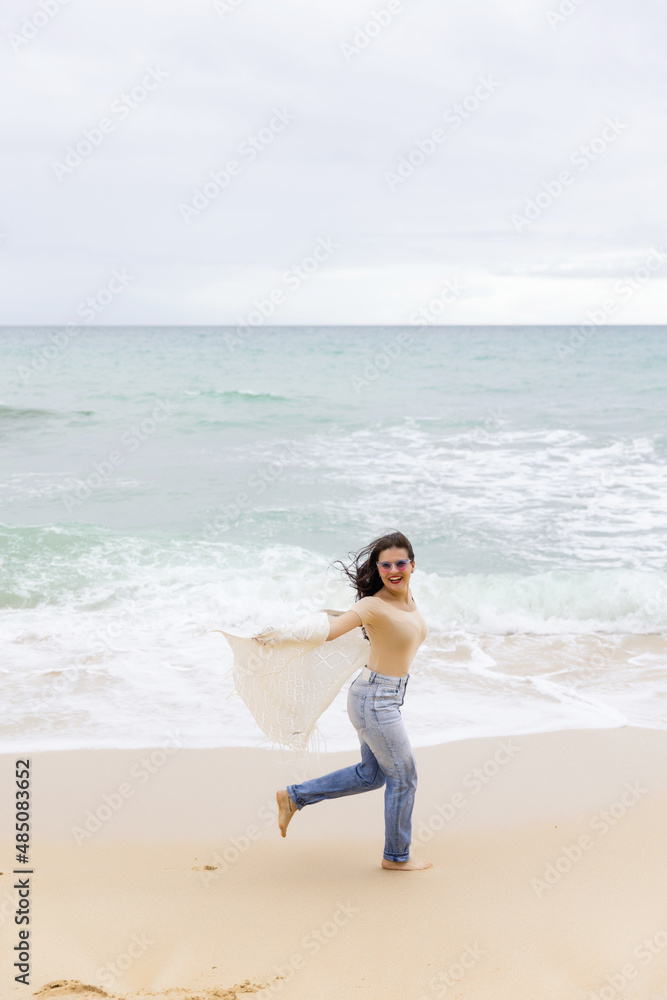 young beautiful girl having fun on the beach in Portugal against the backdrop of the Atlantic Ocean young beautiful girl having fun on the beach in Portugal against the backdrop of the Atlantic Ocean