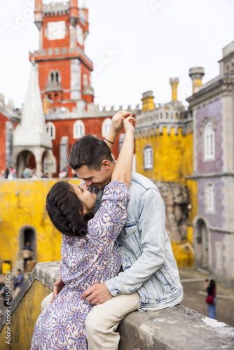 Young beautiful couple walking near National Palace of Pena in Portugal