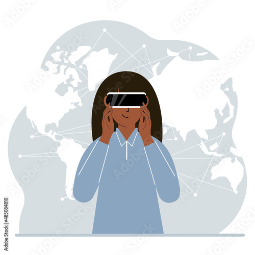 The concept of augmented or extended reality. Woman wearing 3D glasses or virtual reality headset. On the background of the world map.