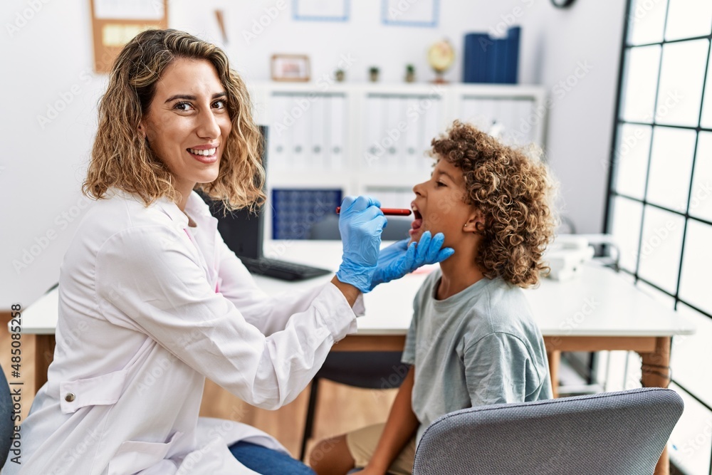 Mother and son smiling confident examining thoat at clinic Mother and son smiling confident examining thoat at clinic