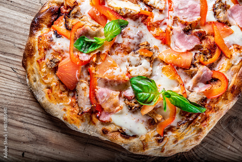 flatbread Pepperoni roman Pizza with Mozzarella cheese, chicken, ham, Tomato sauce, pepper, Spices. Italian pizza on wooden background