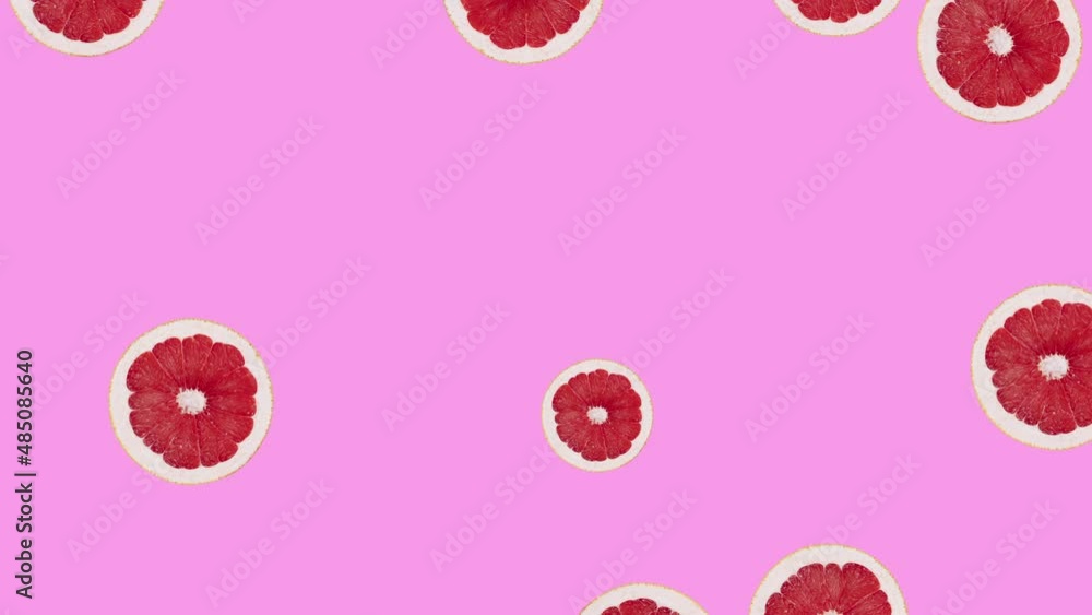 Minimal motion design - Grapefruit slice rotating and moving down at pink color background. Trendy colors and style graphics. Seamless looping animation. Minimal motion design - Grapefruit slice rotating and moving down at pink color background. Trendy colors and style graphics. Seamless looping animation.