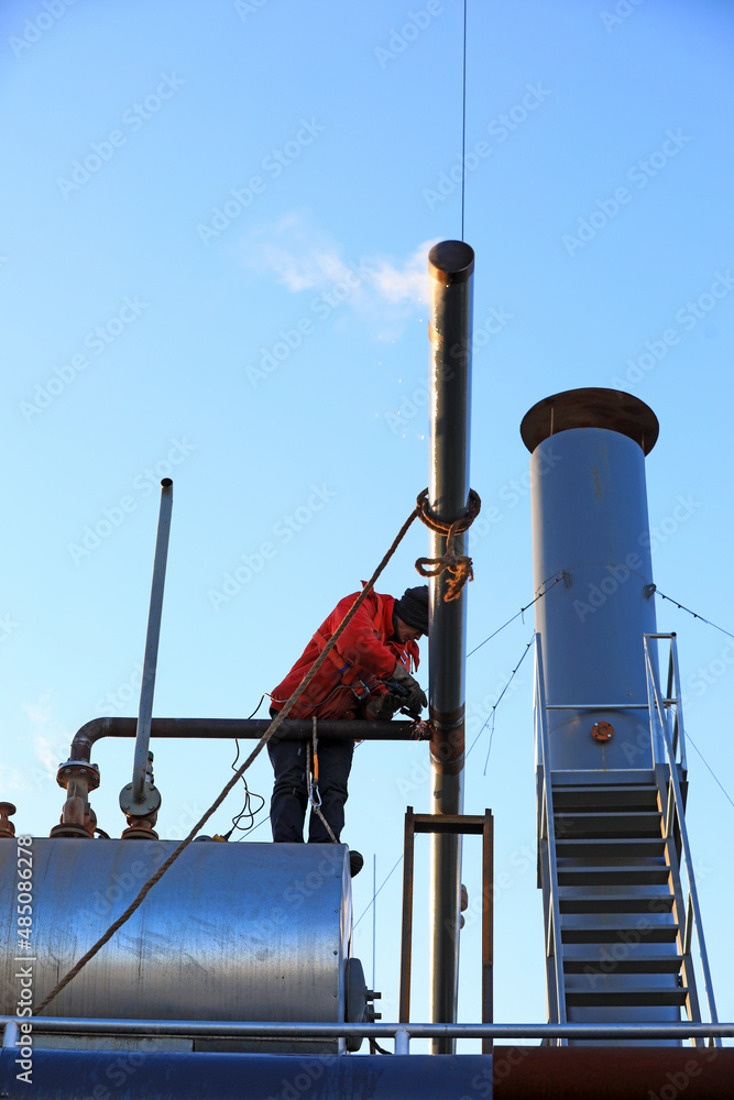 Naklejka premium Workers are welding steam transmission pipes in a biogas power plant, North China