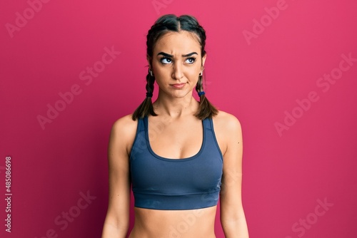 Young brunette girl wearing sportswear and braids skeptic and nervous, frowning upset because of problem. negative person. © Krakenimages.com